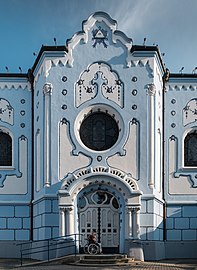 Man on a wheelchair prays in front of the North side entrance of the Church of St. Elisabeth (Blue Church) (Bratislava, Slovakia)