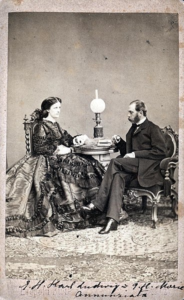 Maria Anunciata and her husband Archduke Karl Ludwig sitting at a table, ca. 1870