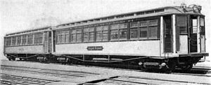 Ein Foto von IRT-Composite-Prototypen. Dieses Foto ist in Schwarzweiß und zeigt zwei hölzerne Triebwagen, gebaut um 1902, auf einigen Bahngleisen.