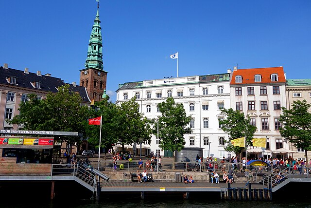 Nordic Council headquarters in Copenhagen. White building with Norden sign and flag at street Ved Stranden No. 18.