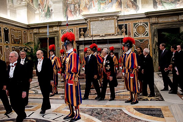 U.S. President Barack Obama escorted through the Clementine Hall by papal gentlemen wearing the insignia of Knight Grand Cross, 2009