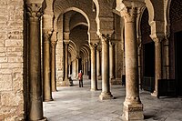 Innenansicht des südlichen Portikus, der als Narthex für den Gebetsraum dient.  Die Säulen, die gebrochene Hufeisenbögen tragen, haben verschiedene Sockel und Kapitelle.