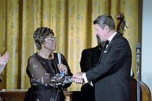 Fitzgerald shakes hands with President Ronald Reagan after performing in the White House, 1981 President Ronald Reagan and Ella Fitzgerald.jpg