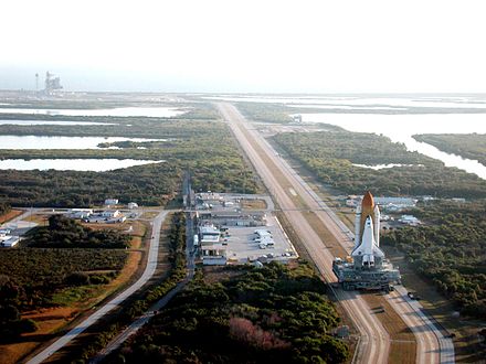 A Crawler-Transporter ferrying Space Shuttle Atlantis to launch pad 39-A for the STS-98 mission.