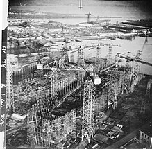 Two aircraft carriers under construction during the Second World War, Magnificent and Powerful, both of which would end up in Canadian service postwar Shipbuilding in Belfast, Northern Ireland, November 1944. A28022.jpg