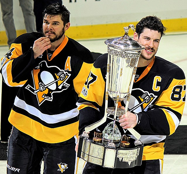 Chris Kunitz (left) and Captain Sidney Crosby (right) with the Prince of Wales Trophy after winning game seven of the Eastern Conference Final.