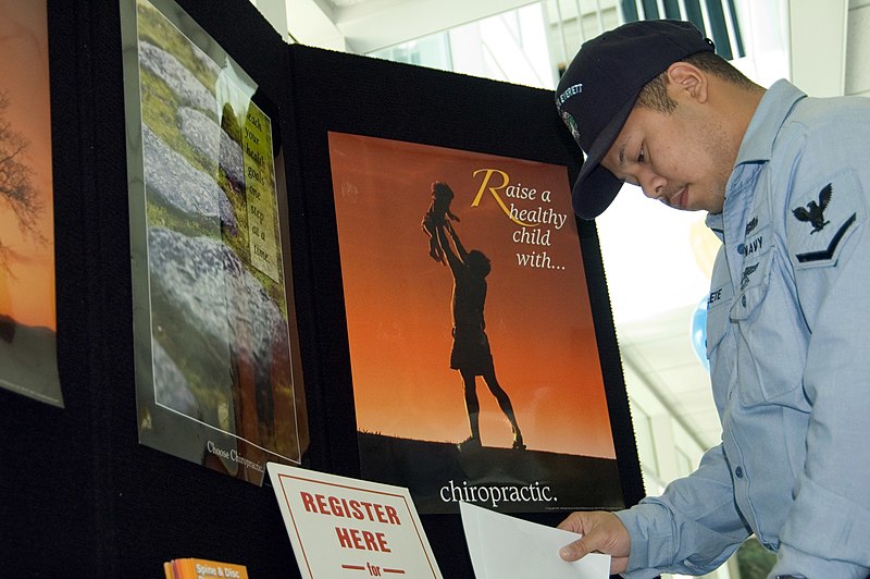 File:US Navy 070517-N-7431W-001 Culinary Specialist 2nd Class Dominique Poblete, assigned to supply department at Naval Station Everett BEQ Staff, looks over information about back alignment at the spinal screening booth.jpg