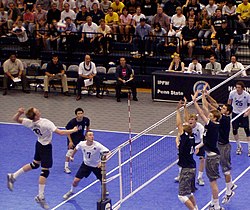 Volleyball kill shot three blockers.jpg