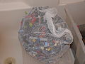 Transfer to mesh bag and rinse in bathtub.