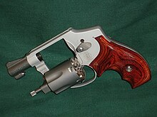 A Smith & Wesson Model 642 revolver with an open cylinder and ergonomic rosewood grips 642 ls.jpg