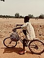 A boy riding bicycle from school