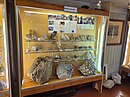 A showcase with silicate minerals and two calcite specimens from the Landsverk 1 quarry in Evje.