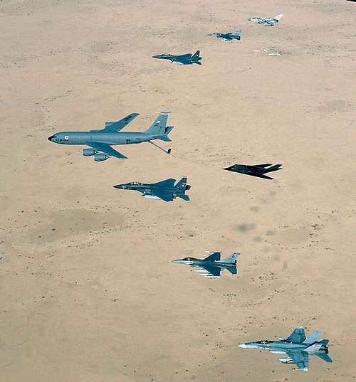 An RAAF F/A-18 with a USAF KC-135, two F-15Es, an F-117, two F-16s and a RAF Tornado over Iraq