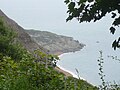 The cliffs and beach below Blackgang Chine, Isle of Wight, viewed from "Frontierland", a section of the theme park that has now developed around the area.