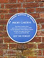 Blue plaque outside the Priory Gardens in Orpington.