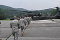 Cadets participating in the cadet troop leadership training program with the 1st Battalion, 38th Field Artillery Regiment, 210th Fires Brigade walk out to a UH-60 Black Hawk helicopter to take a trip around Camp 130808-A-WG463-018.jpg