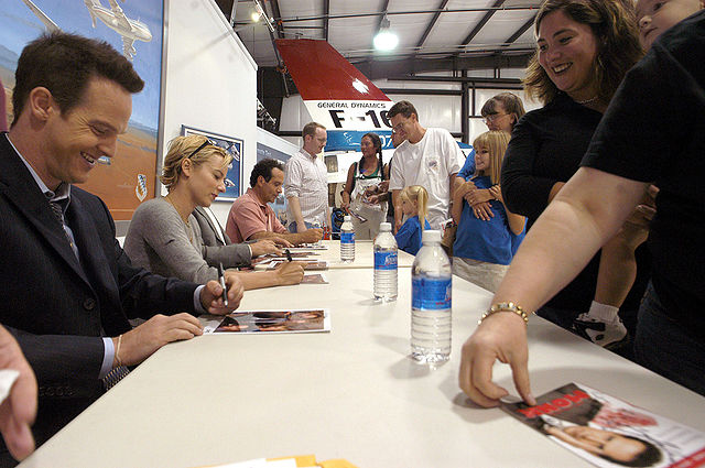The cast of Monk signing autographs at Edwards Air Force Base. From left to right: Jason Gray-Stanford, Traylor Howard, and Tony Shalhoub.
