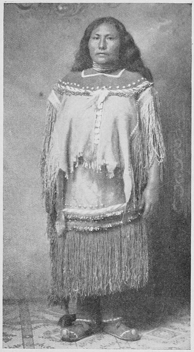 Full-length photograph of a young woman in traditional dress