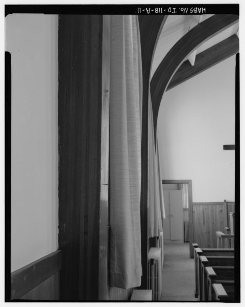 File:Detail of laminated arch beams, radiators, pews and portion of the office to the left of the sanctuary, facing north - Mountain Home Air Force Base, Base Chapel, 350 Willow HABS ID,20-MOUHO,1A-11.tif