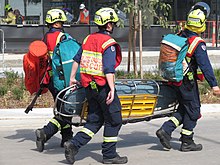 Firefighters with a stokes basket and rope rescue kit FRNSW Rescue Firefighters.jpg