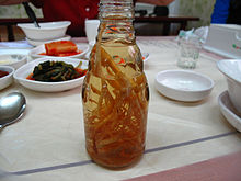 Ginseng roots in a bottle of liquid