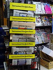 The International New York Times on a branded newsstand in Hong Kong, 11 March 2016 HK Central night Yun Xian Jie Wyndham Street shop 7-11 newspaper stand name display March 2016 DSC.JPG