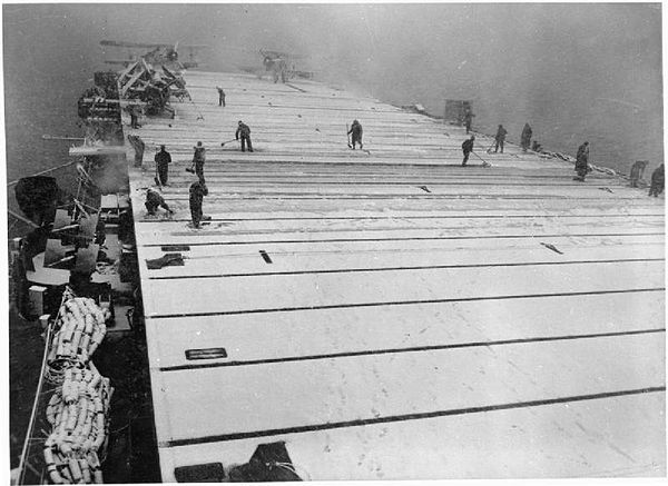 Fencer, May 1944, clearing snow from the flight deck during an Arctic convoy. Two Fairey Swordfish aircraft of 842 Naval Air Squadron, Fleet Air Arm c