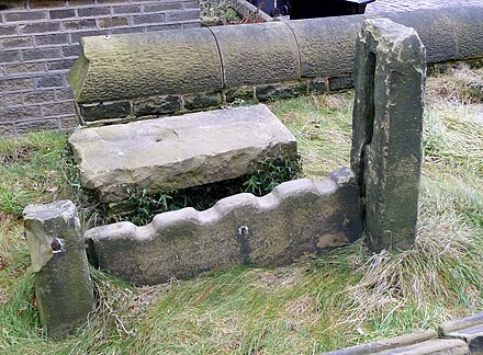 Stocks in the churchyard of St Mary's church, Honley, West Yorkshire.