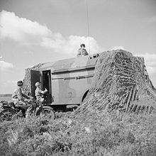 An AEC Armoured Command Vehicle and despatch riders of the Royal Corps of Signals at the divisional HQ of an armoured division on exercise in the UK, August 1941. IWM-H-13261-AEC-ACV-19410830.jpg