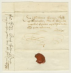 Vanha kirje, jossa on koristeellista tekstiä ja kuviointia sekä punainen sinetti.