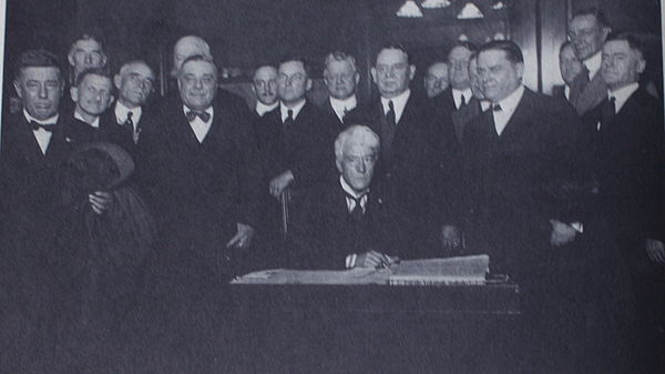 Judge Kenesaw Mountain Landis signs the agreement to become Commissioner of Baseball, November 12, 1920.