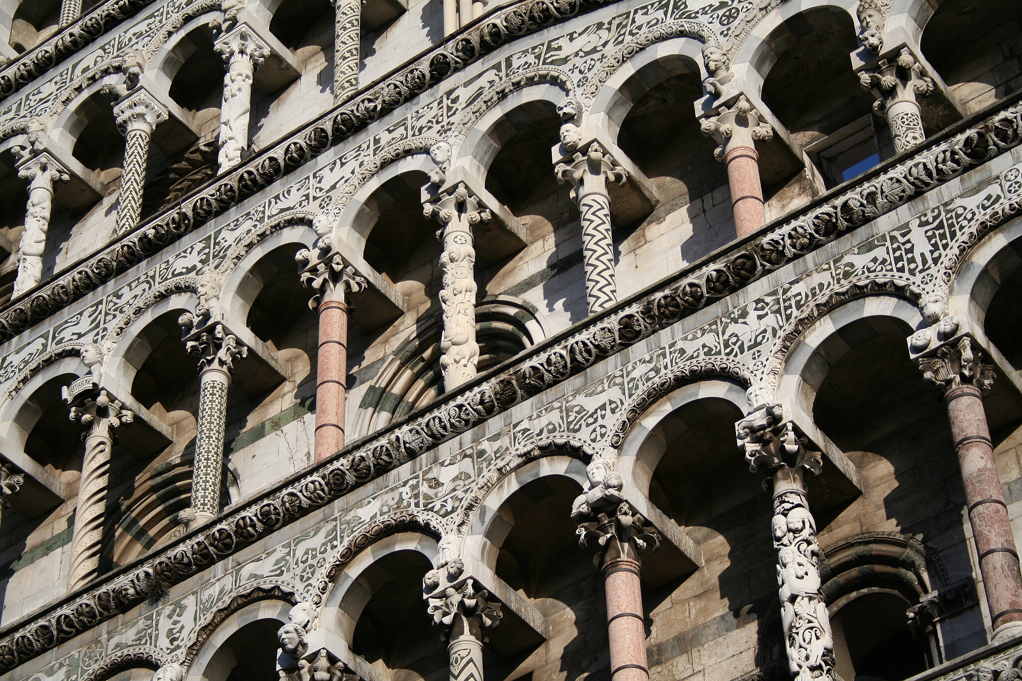 the pillars of the front facade of the San Michele in Foro church in Lucca