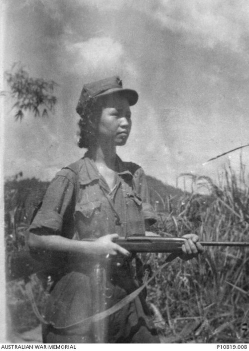 Leader of the Malayan Communist Party Lee Meng holding a rifle during the Malayan Emergency, 1951