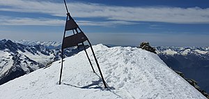 Triangulation pyramid and stone man on the summit of Pizz Gallagiun