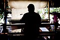 A person weaving silk at a loom, Ban Tha Sawang, Surin Province, Thailand