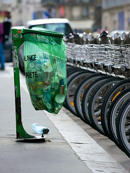 A plastic bag used to collect waste on a street in Paris