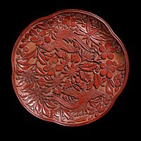 Tray with two birds against a background of plum blossom and flowers, 19 cm wide, late Song, 13th century (oblique view). No overlapping of forms, and relatively wide strips of background visible.