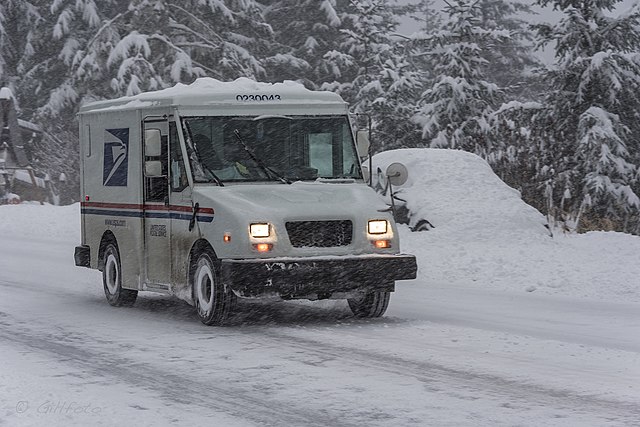 A USPS truck in the snow
