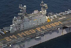 Marines from the 24th Marine Expeditionary Unit aboard the USS Nassau (LHA 4), spelling out “24 MEU PROUD!”, 2003