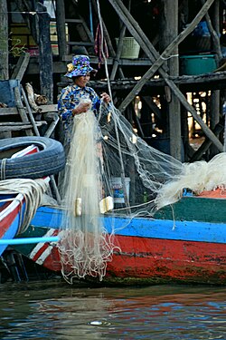 Woman checking the net in Kampong Phlouk, Siem Reap Province, Cambodia