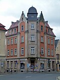 House in a corner with a shop