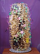 Tall šakotis, a spit cake, decorated with chocolate and flowers.