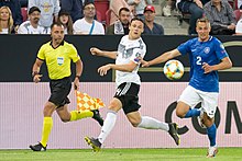 Kams (right) playing for Estonia against Germany in 2019. 2019-06-11 Fussball, Manner, Landerspiel, Deutschland-Estland StP 2196 LR10 by Stepro.jpg