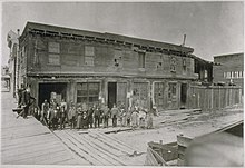 Abe Warner's Cobweb Palace. Francisco Street. Abe Warner in plug hat on the left. Abe Warner's Cobweb Palace. Francisco Street. Abe Warner in plug hat on the left.jpg