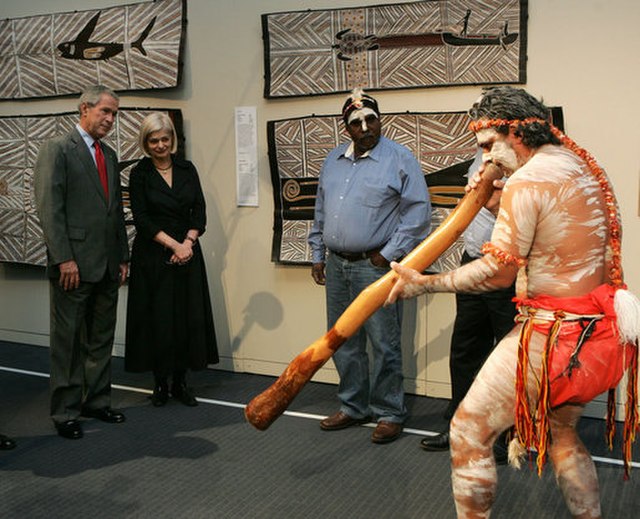 President George W. Bush enjoys a performance of Aboriginal song and dance during a 2007 visit to the Australian National Maritime Museum in Sydney wi