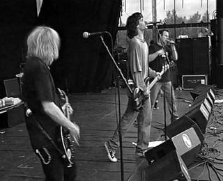 Black-and-white photo of a punk band performing live