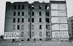Urban decay in the US: the South Bronx, New York City, was exemplar of the federal and local government's abandonment of the cities in the 1970s and 1980s; the Spanish sign reads "FALSAS PROMESAS", the English sign reads "BROKEN PROMISES". BrokenPromises JohnFekner.jpg