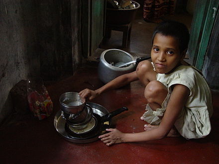 Child maid servant in India. Child domestic workers are common in India, with the children often being sent by their parents to earn extra money, although it is banned by the government.