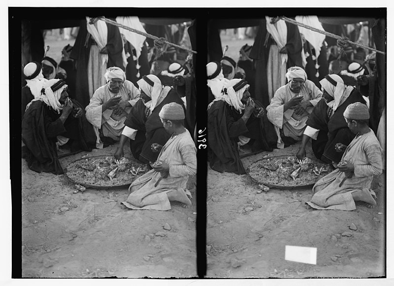 File:Close of the 1930 locust campaign. Bedouins racing and feasting at Beersheba on June 30th, 1930. Part of the Beersheba feast. Group of Bedouins eating from a tray of savory rice and mutton LOC matpc.02959.jpg