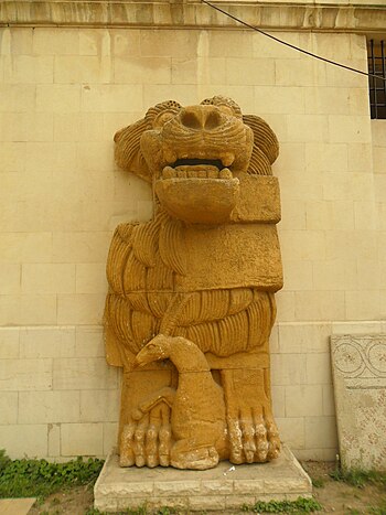 English: An ancient statue of a lion with a ga...